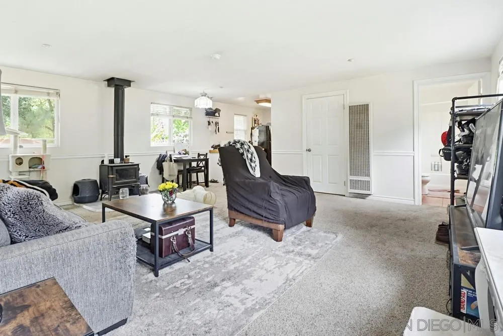 2275 Honey Springs Road Jamul, CA 91935 - Photo 6 of 17 a living room with furniture a window and a flat screen tv