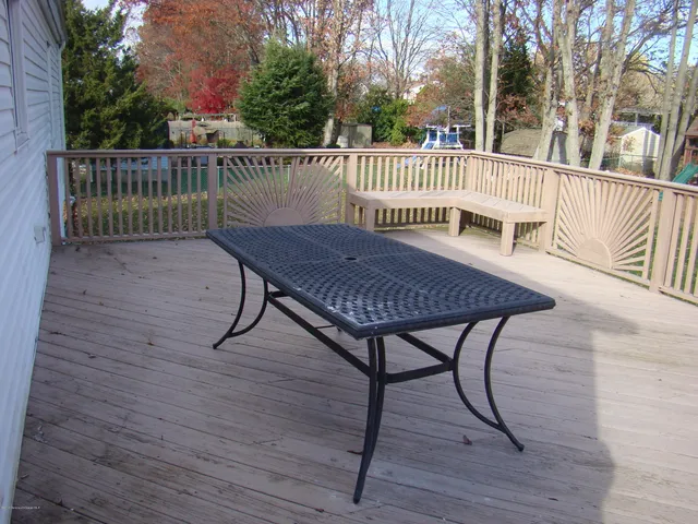 a view of a roof deck with wooden floor and fence