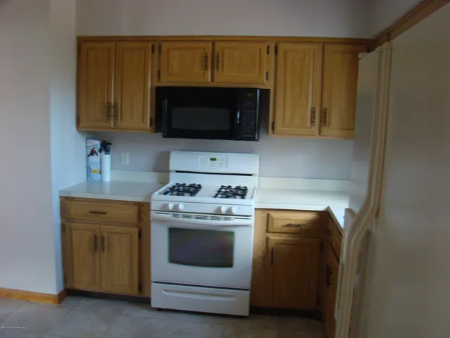 a view of a room with wooden floor and chandelier