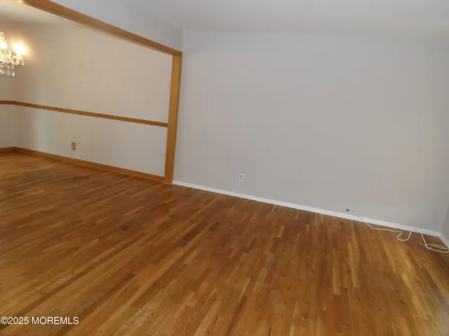 an empty room with yellow lighting and windows