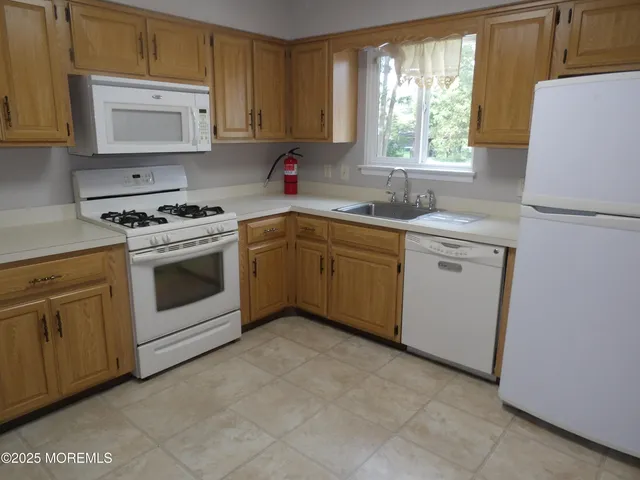 a kitchen with a stove sink and refrigerator
