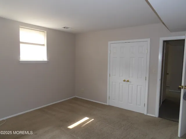 a living room with furniture and a ceiling fan