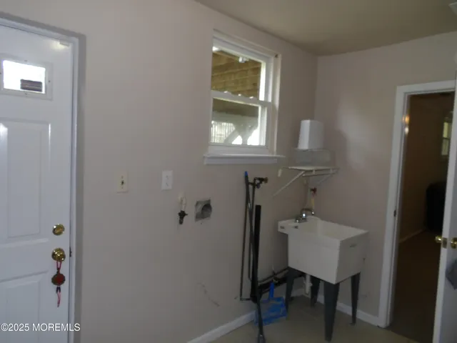 a white toilet sitting next to a white sink