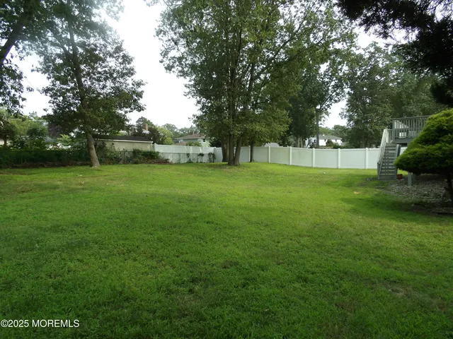 a view of a big yard with a trees