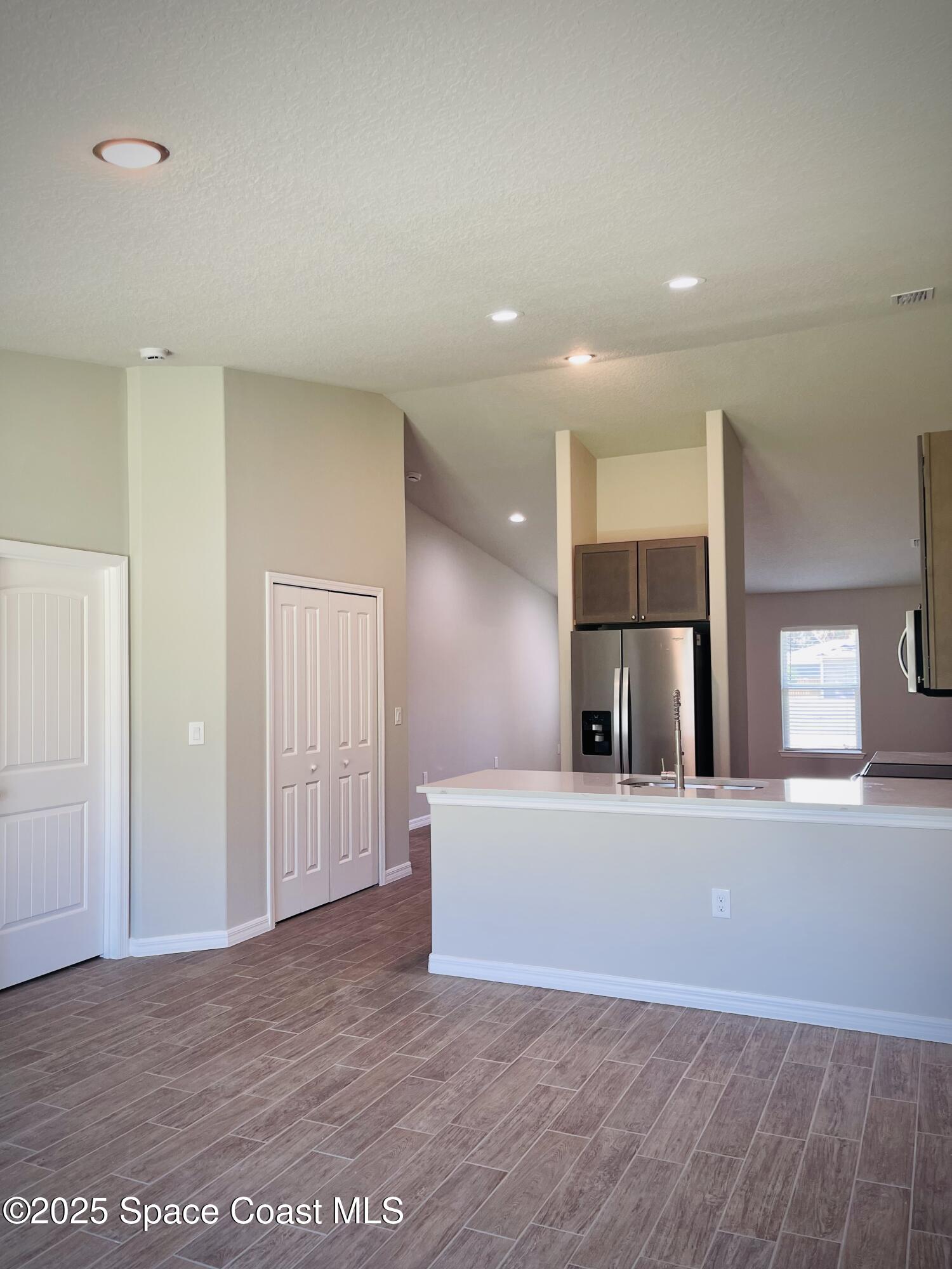 334 Frederick Street Southwest Palm Bay, FL 32908 - Photo 15 of 39 a view of an empty room with a kitchen