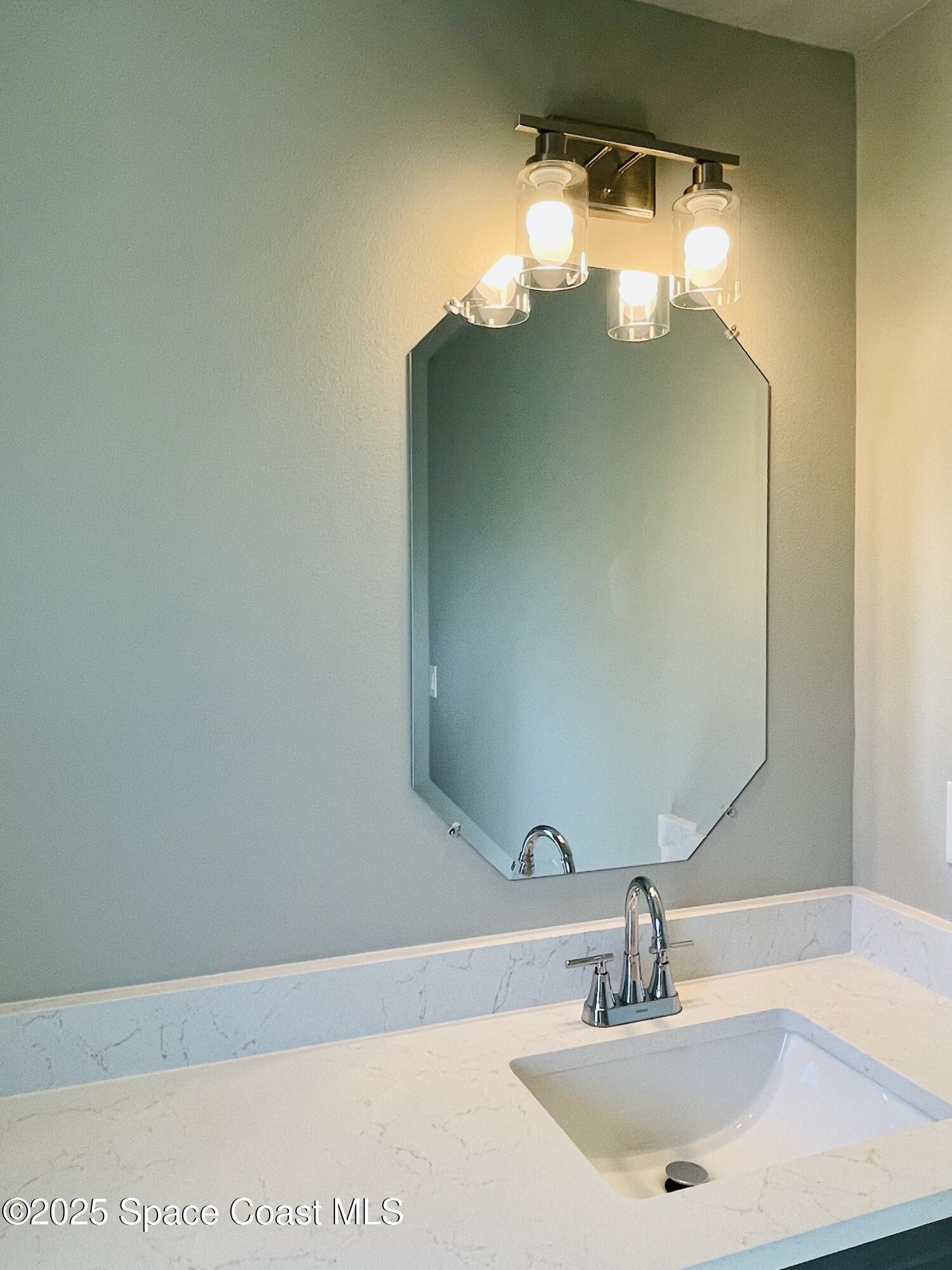 334 Frederick Street Southwest Palm Bay, FL 32908 - Photo 20 of 39 a bathroom with a sink and a mirror