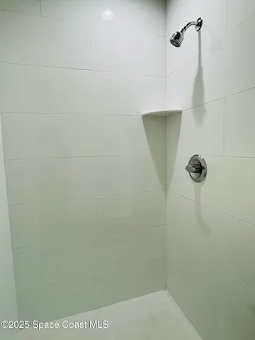 a bathroom with a granite countertop toilet a sink and shower