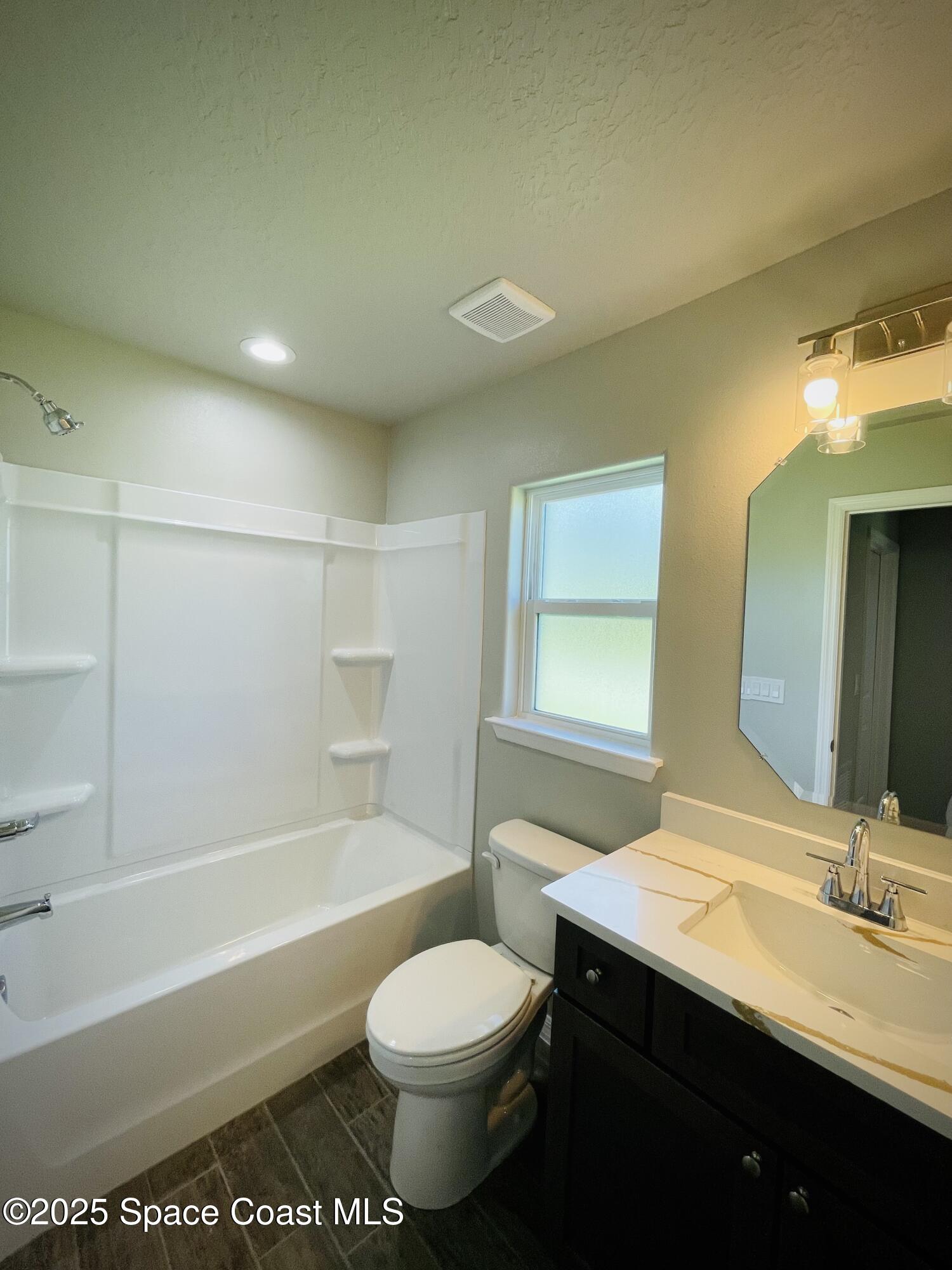 334 Frederick Street Southwest Palm Bay, FL 32908 - Photo 29 of 39 a bathroom with a sink a toilet and bathtub