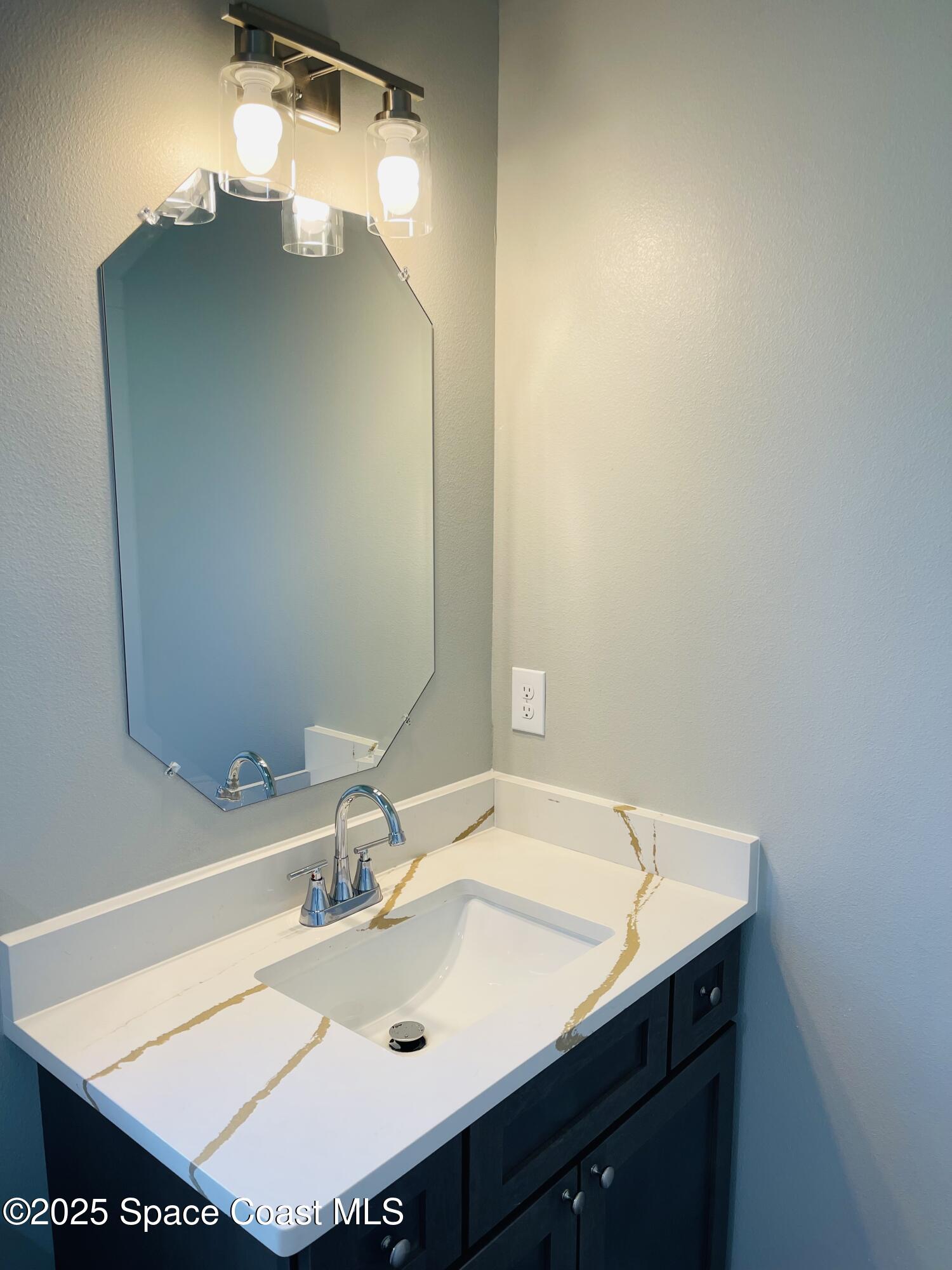 334 Frederick Street Southwest Palm Bay, FL 32908 - Photo 31 of 39 a bathroom with a sink and a mirror