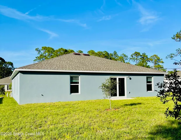 a view of house with backyard space and garden