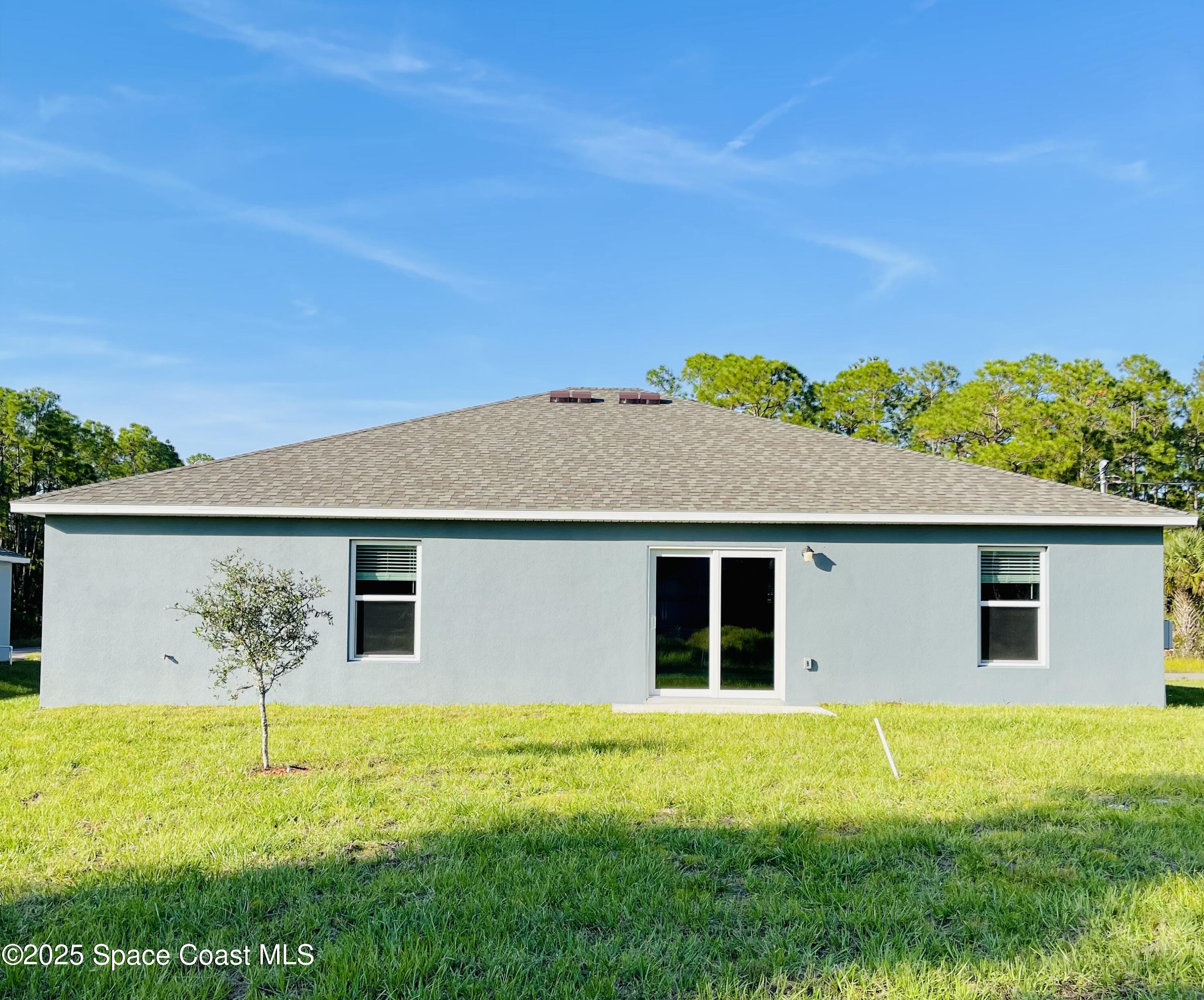 334 Frederick Street Southwest Palm Bay, FL 32908 - Photo 39 of 39 a view of house with backyard space and garden