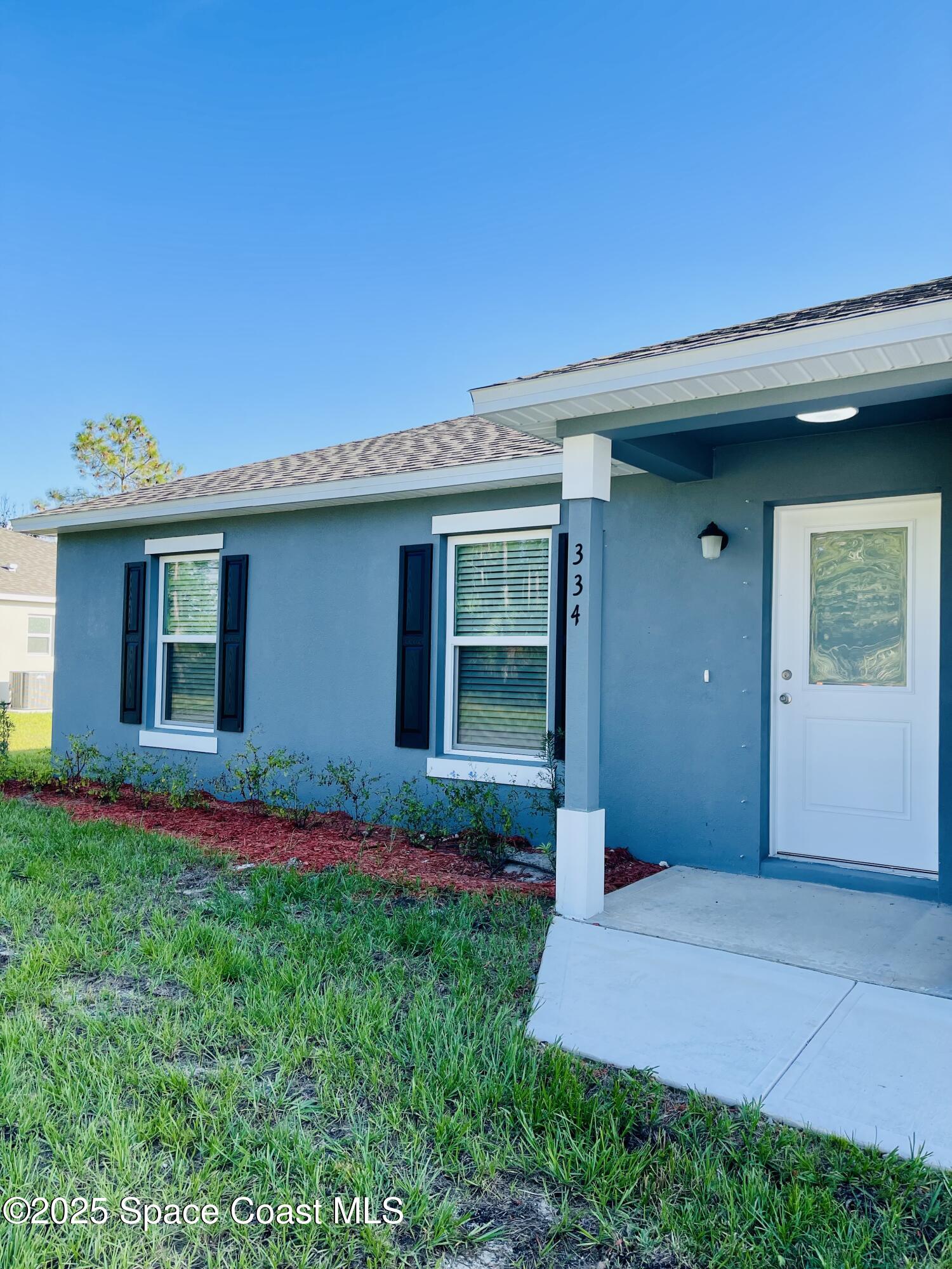 334 Frederick Street Southwest Palm Bay, FL 32908 - Photo 5 of 39 a front view of house with yard