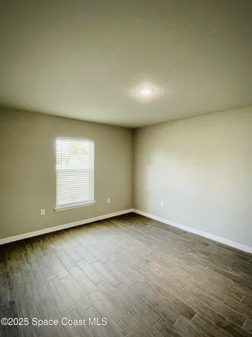 an empty room with wooden floor