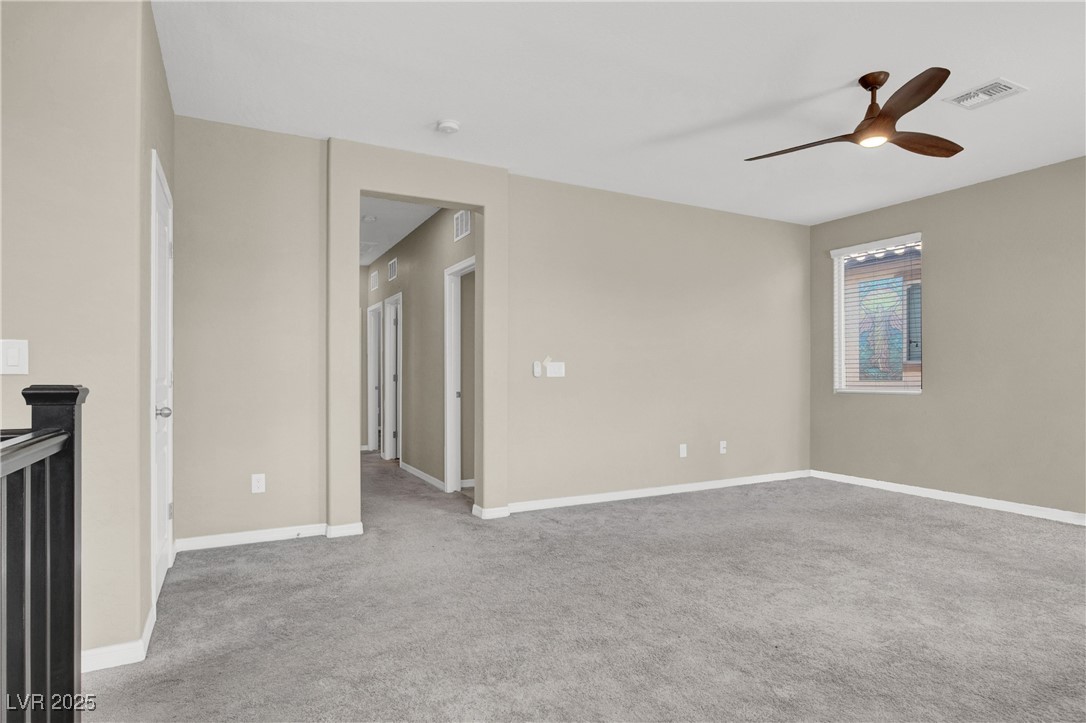 10976 Bluebell Basin Road Las Vegas, NV 89179 - Photo 24 of 40 Carpeted empty room with ceiling fan, baseboards, and a smoke detector
