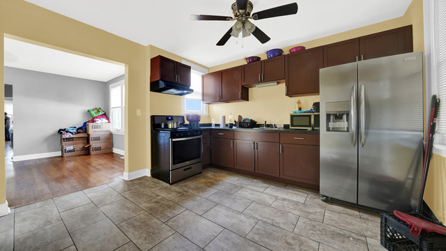 2913 West 63rd Street Chicago, IL 60629 - Photo 12 of 23 a kitchen with stainless steel appliances granite countertop a refrigerator a stove top oven a sink and dishwasher