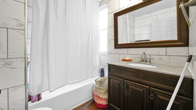 2913 West 63rd Street Chicago, IL 60629 - Photo 15 of 23 a bathroom with a sink and a mirror