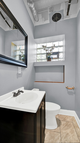 2913 West 63rd Street Chicago, IL 60629 - Photo 10 of 23 a bathroom with a sink and a mirror