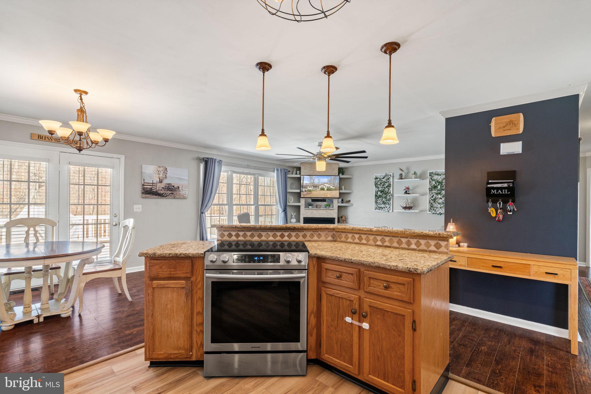 28485 Morel Way Rhoadesville, VA 22542 - Photo 11 of 42 a kitchen with stainless steel appliances granite countertop a stove a sink and a wooden floors