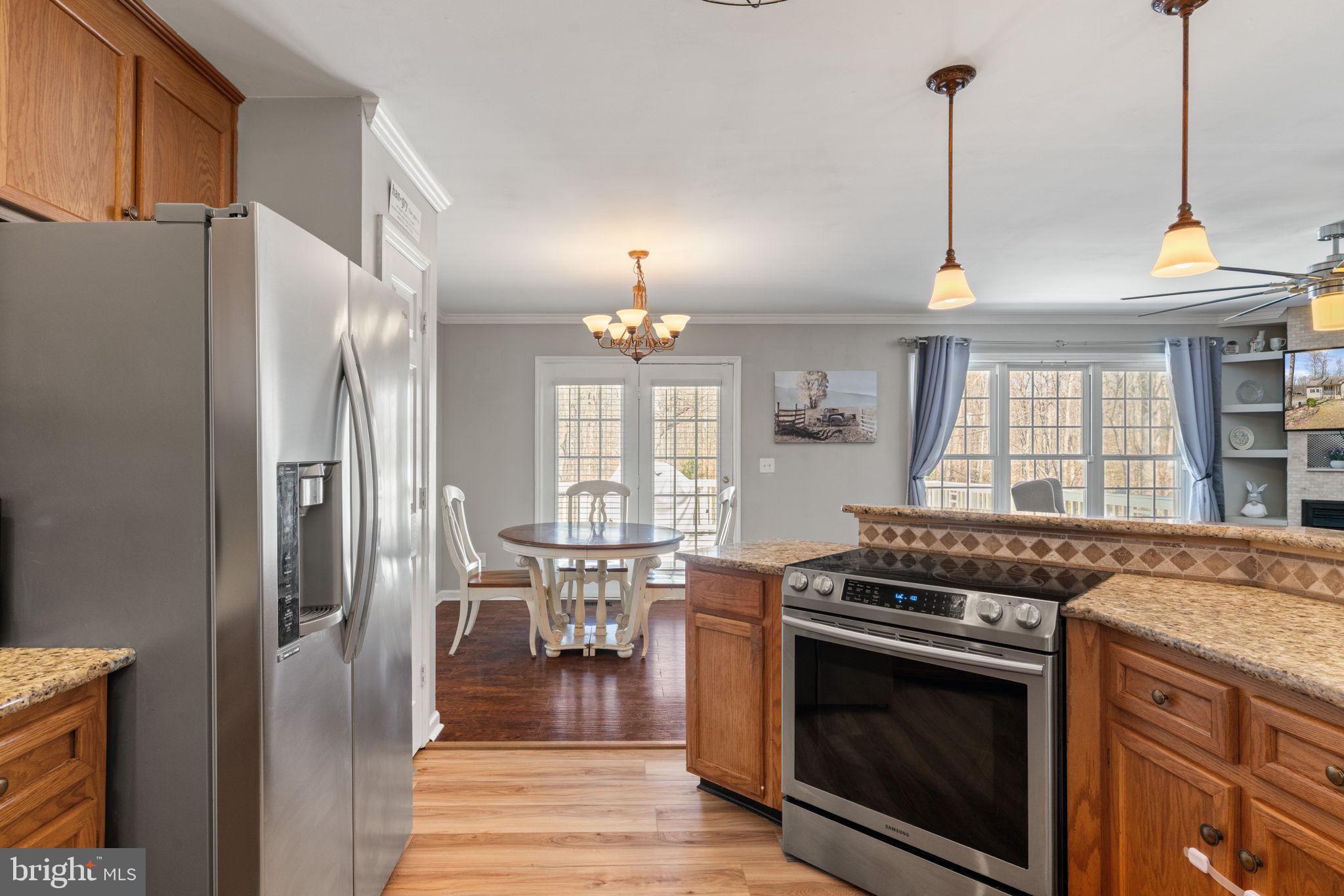 28485 Morel Way Rhoadesville, VA 22542 - Photo 12 of 42 a kitchen with stainless steel appliances granite countertop a stove a refrigerator and a stove