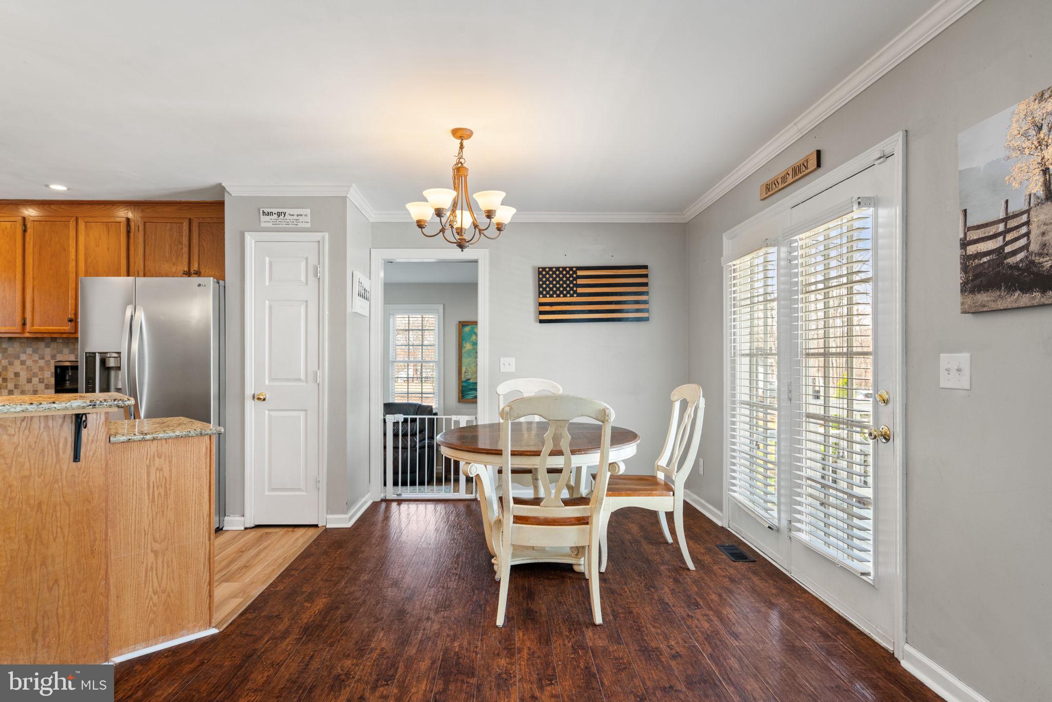 28485 Morel Way Rhoadesville, VA 22542 - Photo 14 of 42 a view of a dining room with furniture window and wooden floor