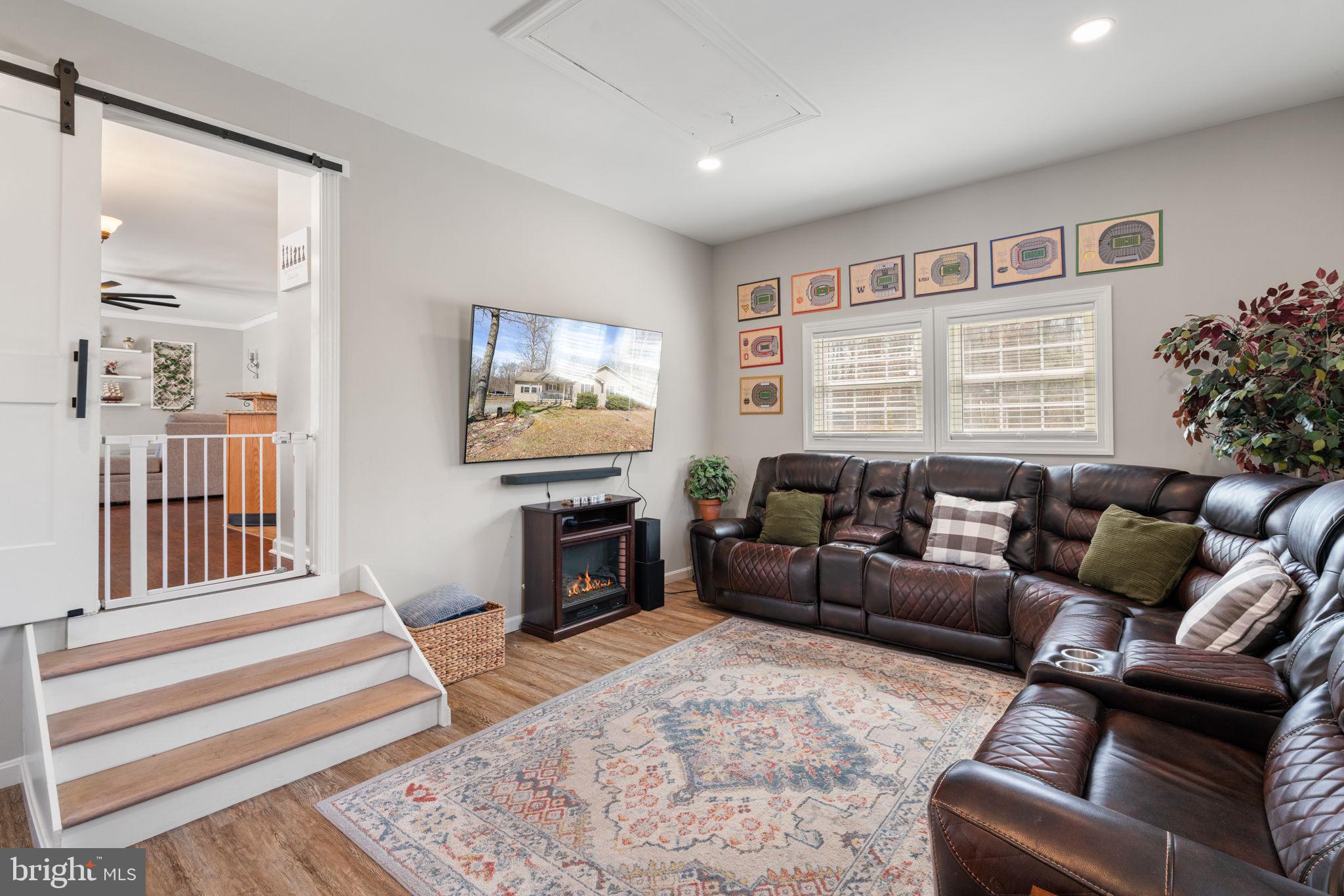 28485 Morel Way Rhoadesville, VA 22542 - Photo 15 of 42 a living room with furniture and a flat screen tv