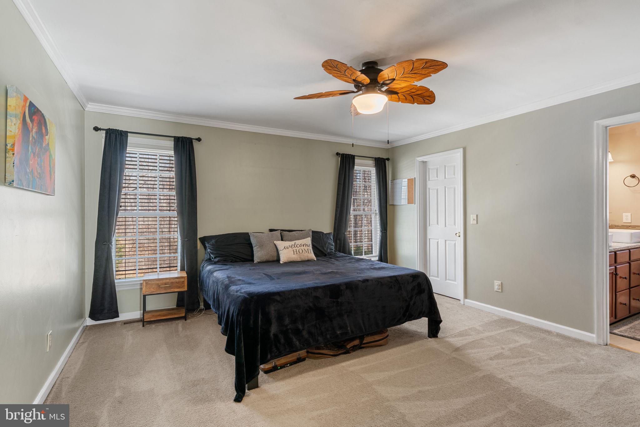 28485 Morel Way Rhoadesville, VA 22542 - Photo 21 of 42 a bedroom with a bed and a chandelier