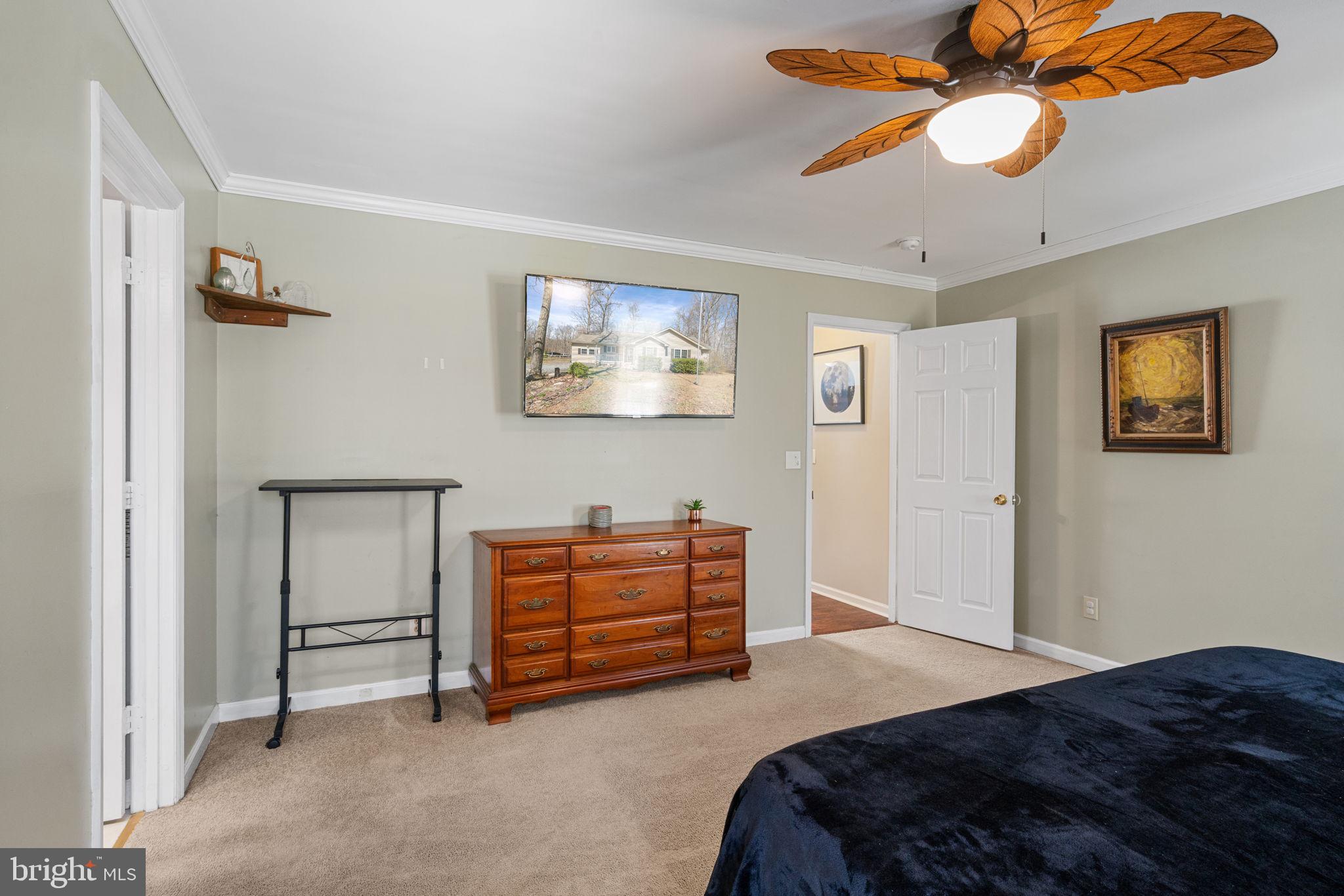 28485 Morel Way Rhoadesville, VA 22542 - Photo 22 of 42 a bedroom with furniture and a chandelier