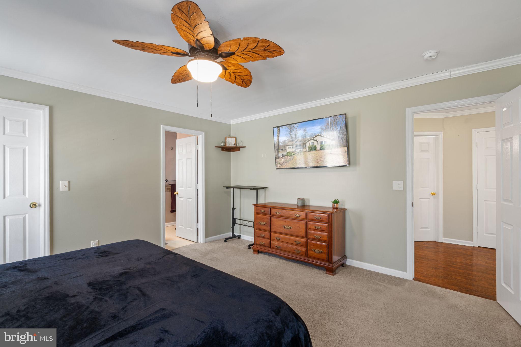 28485 Morel Way Rhoadesville, VA 22542 - Photo 23 of 42 a bedroom with a bed and a lamp on dresser
