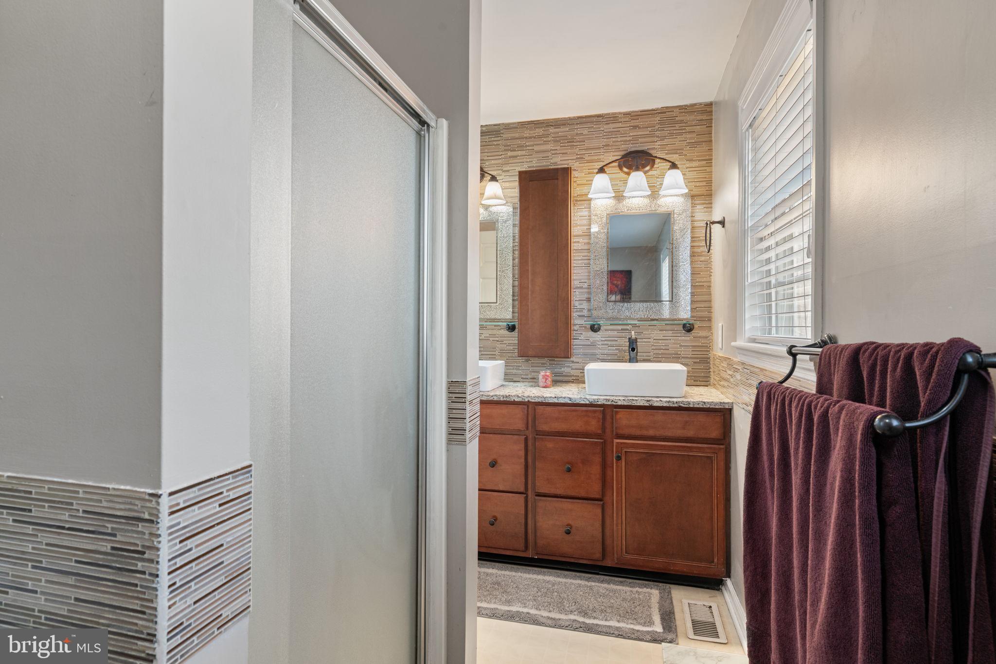 28485 Morel Way Rhoadesville, VA 22542 - Photo 28 of 42 a bathroom with a double vanity sink and a mirror