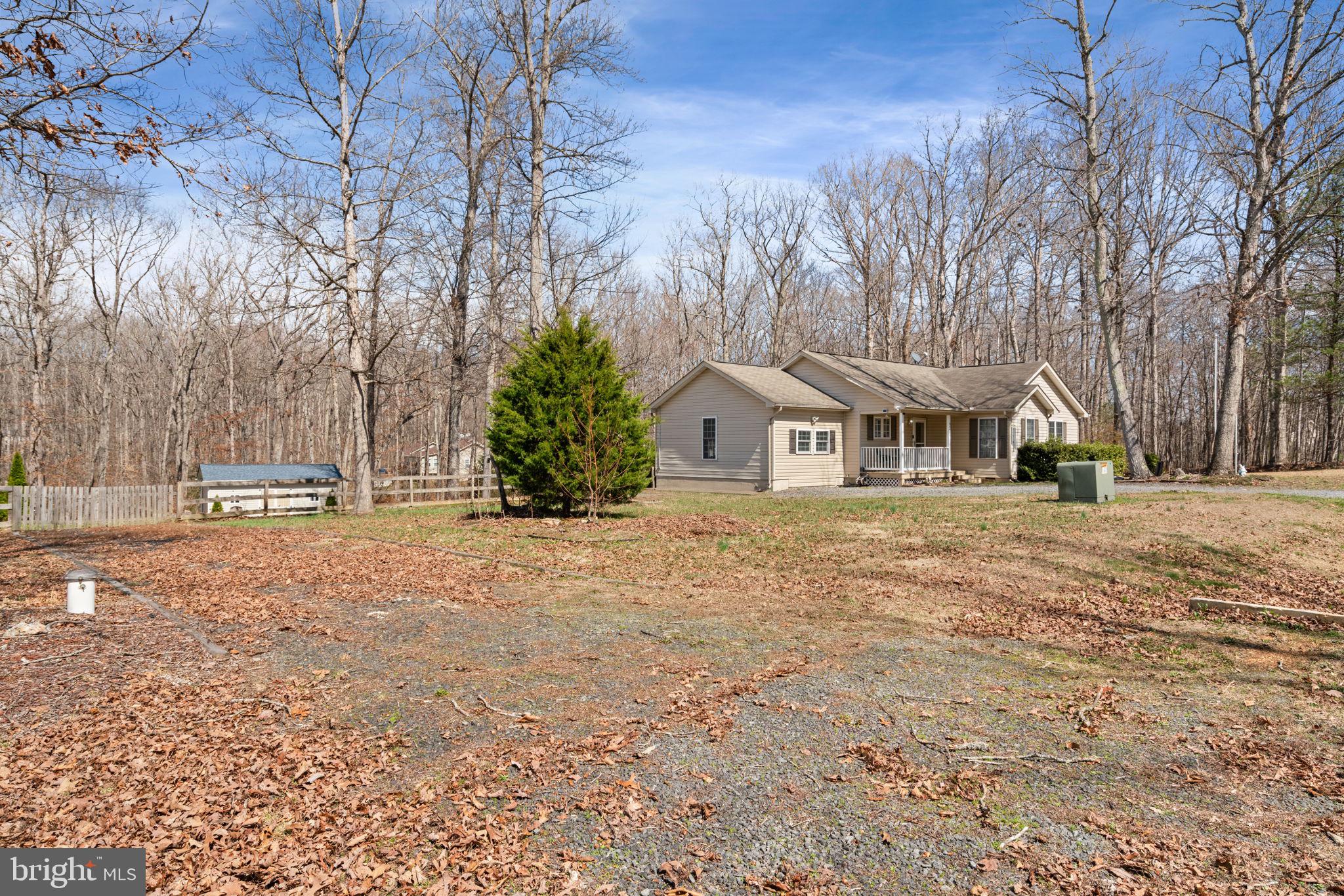 28485 Morel Way Rhoadesville, VA 22542 - Photo 3 of 42 a view of white house with large trees and outdoor space