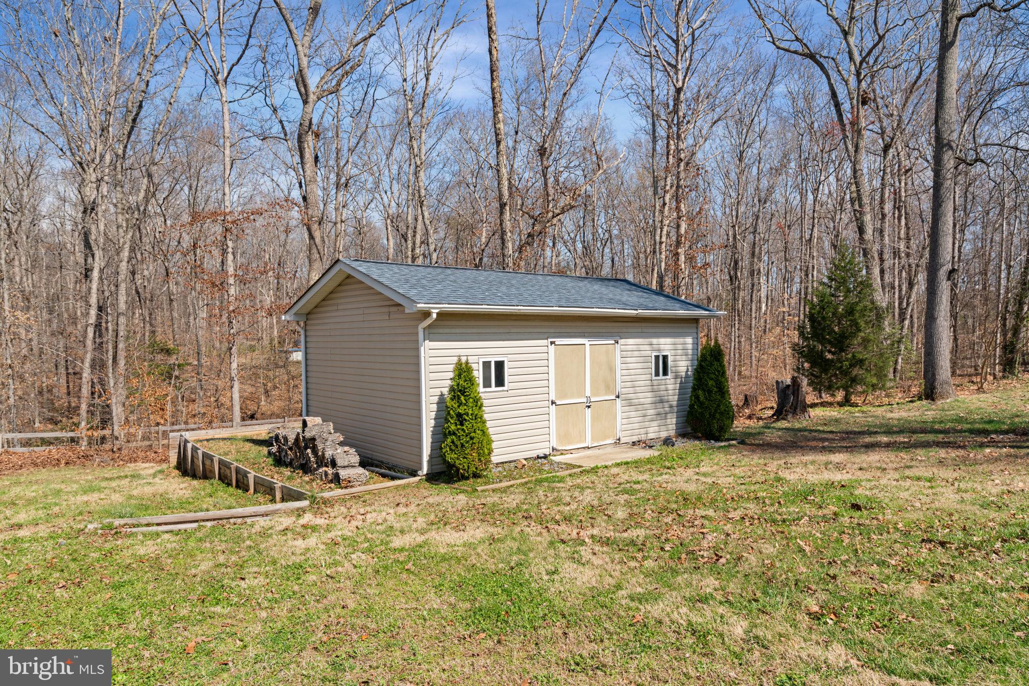 28485 Morel Way Rhoadesville, VA 22542 - Photo 40 of 42 a backyard of a house with table and chairs