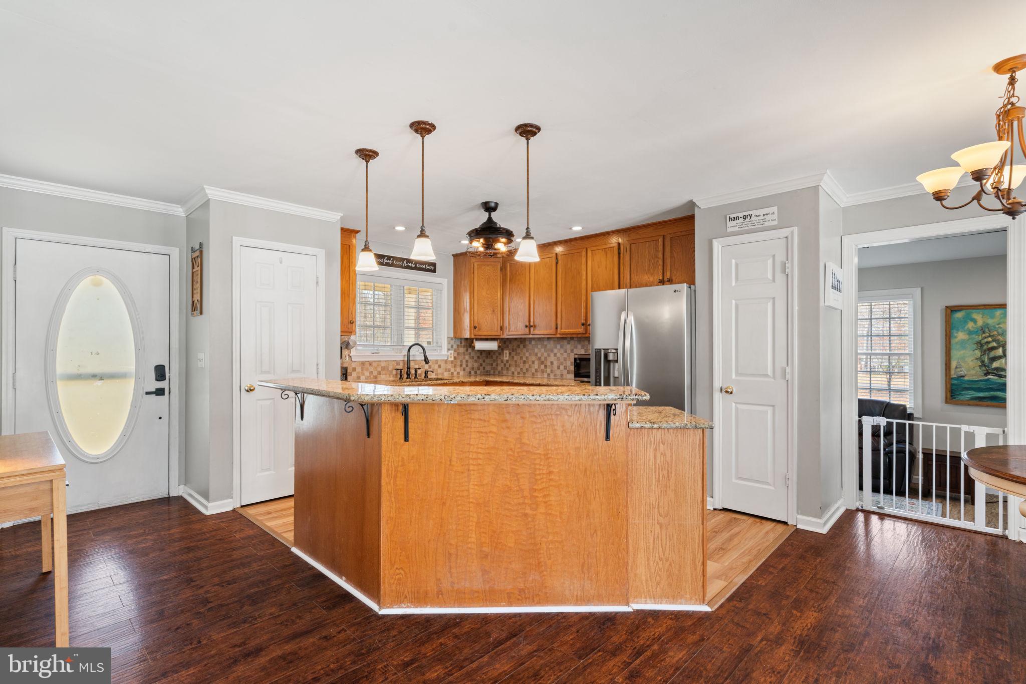 28485 Morel Way Rhoadesville, VA 22542 - Photo 8 of 42 a view of a kitchen with wooden floor and electronic appliances