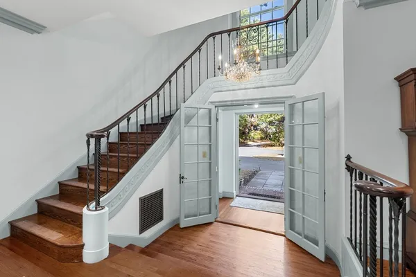 a view of entryway and hall with wooden floor
