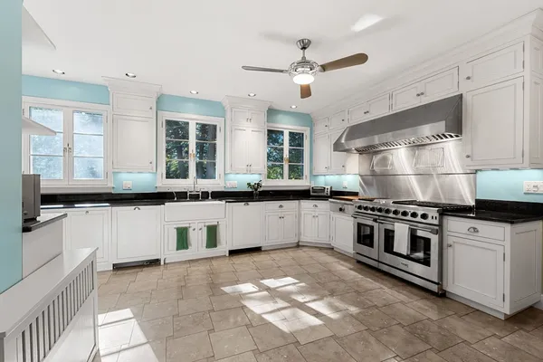 a kitchen with stainless steel appliances and white cabinets