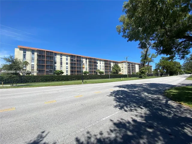 a view of a building with a yard