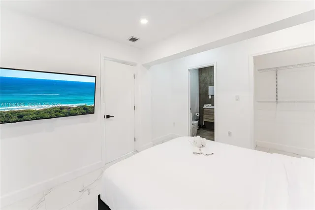 a bedroom with a bed and a view of bathroom