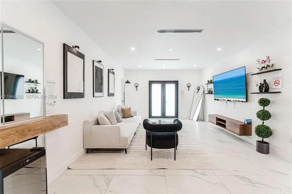 a kitchen with stainless steel appliances granite countertop a table chairs in it and wooden floor