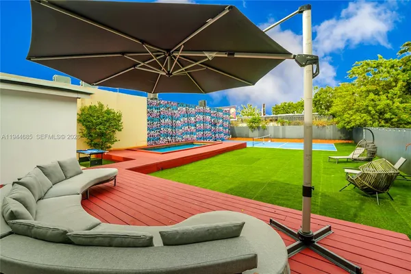 a room with painting on the wall and a window