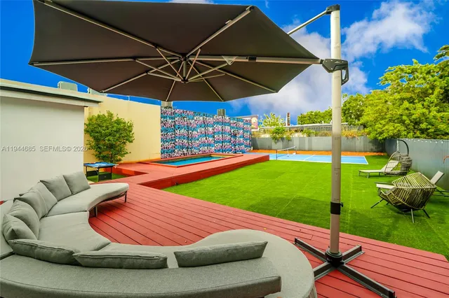 a room with painting on the wall and a window