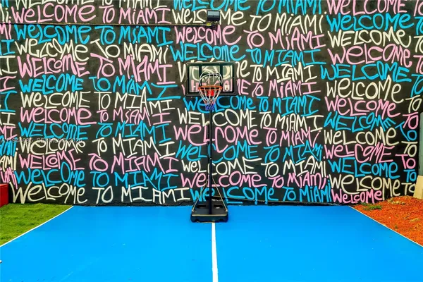 a view of a backyard with chairs potted plants and a fountain