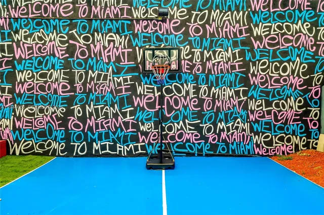 a view of a backyard with chairs potted plants and a fountain