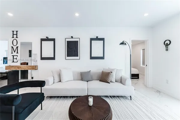 a living room with furniture and gym equipment