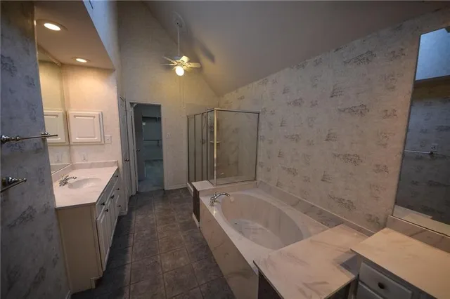 a spacious bathroom with a granite countertop sink a toilet and shower