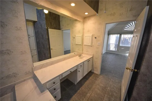 a bathroom with a sink a toilet and mirror