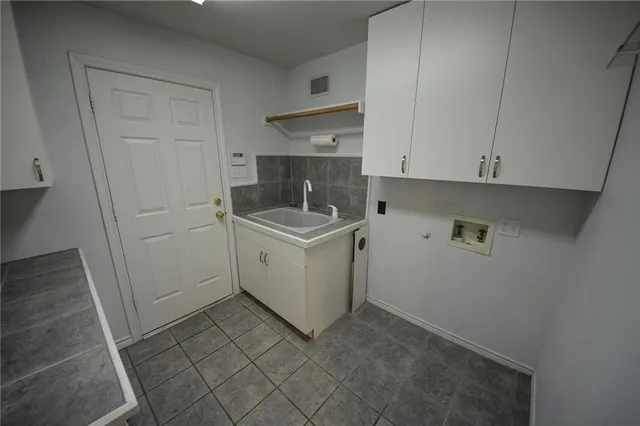 a utility room with cabinets washer and dryer