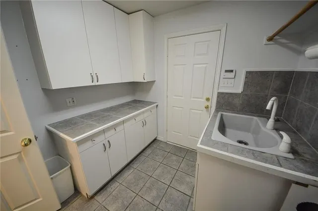 a kitchen with a sink stove and cabinets