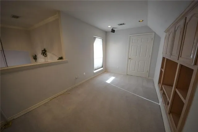 a view of room with window and refrigerator