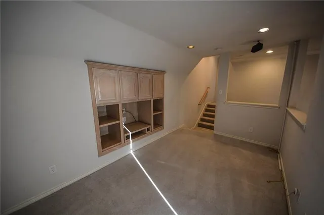 a view of an empty room with stairs
