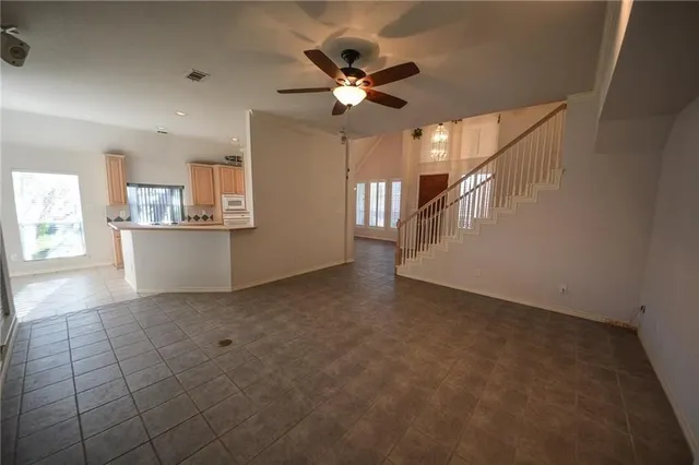 a view of a livingroom with a ceiling fan and window