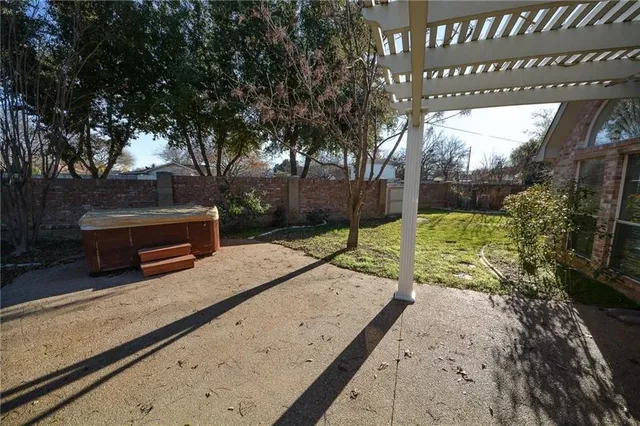 a view of a brick house next to a yard and plants